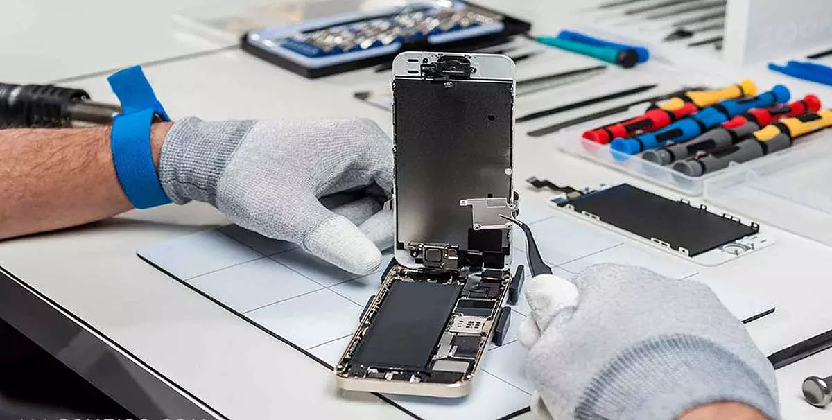 Técnico consertando a tela quebrada de um celular.