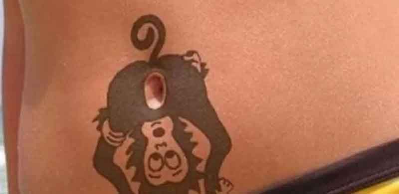 Fora dos limites, a tatu de um macaco, sobre o umbigo.